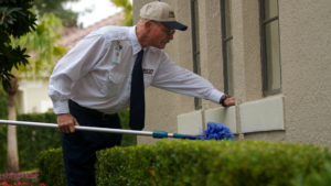 A Massey Services, Inc. technician performing exterior pest control treatment on a building in Melbourne, FL.