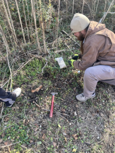 A JPC Exterminating, LLC technician placing bait or a device for wildlife control in New Orleans, LA.