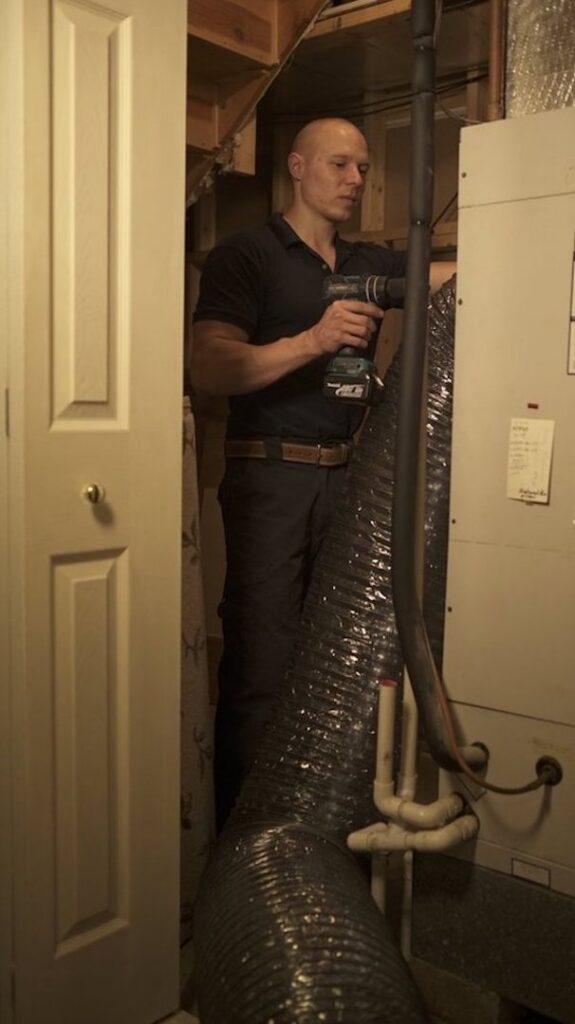 A technician preparing flexible rods for air duct cleaning services by Lowe's Air Duct Cleaning in Fairlawn, OH.
