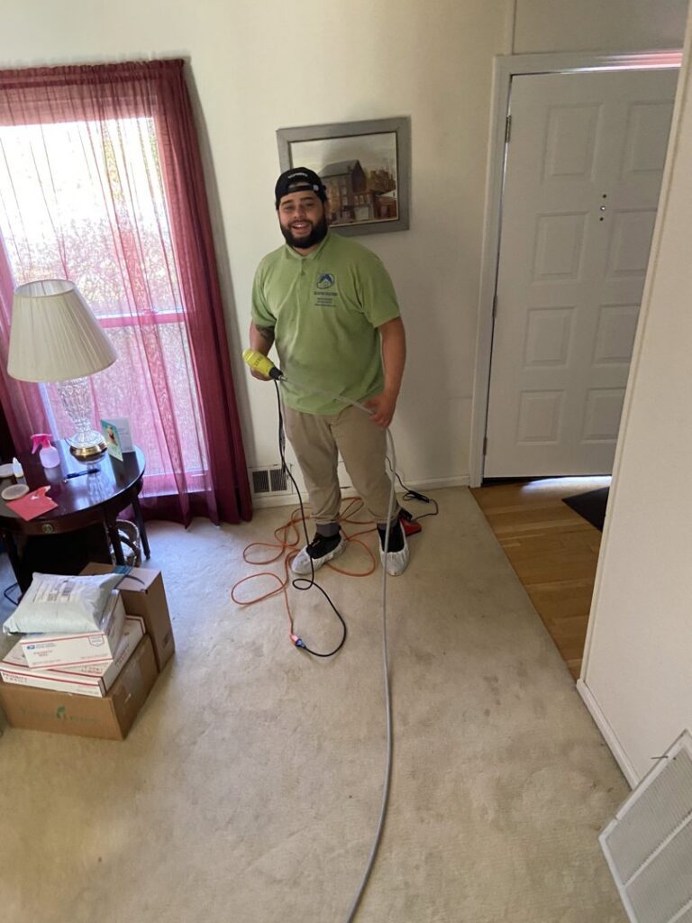 A Clean Air Solutions technician holding a cleaning hose, preparing for duct cleaning service in Gaithersburg, MD.