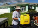 A technician preparing pest control chemicals and equipment for a job at Allstate Termite and Pest Control Inc. in Tampa, FL.