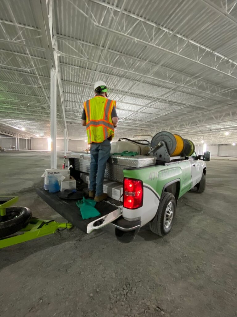 A technician from Action Pest And Turf preparing for a pest control service in Springdale, AR.