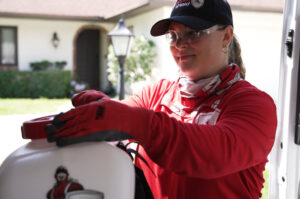 A Mosquito Shield of Savannah technician preparing a backpack sprayer for pest control service in Savannah, GA.