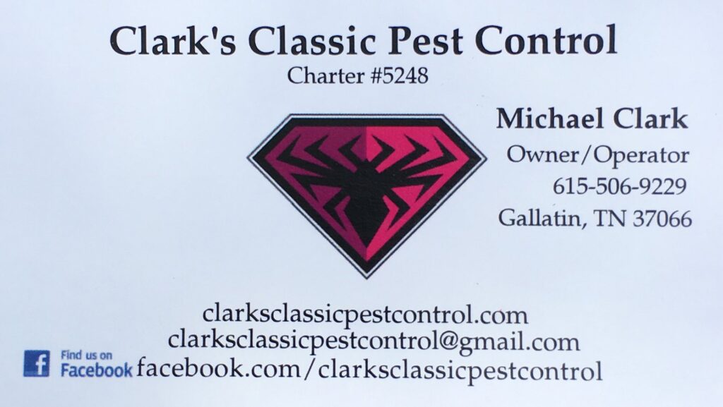 A pest control technician removing cobwebs from the eaves of a house with a long brush for Clark's Classic Pest Control in Nashville, TN.