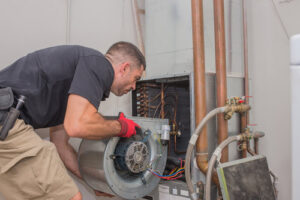 A technician removing a furnace blower motor during service for Daniels HVAC Philadelphia LLC in Philadelphia, PA.