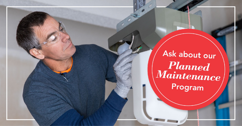 A technician repairing a garage door opener, showcasing services from Overhead Door Company of Central Missouri in Columbia, MO.
