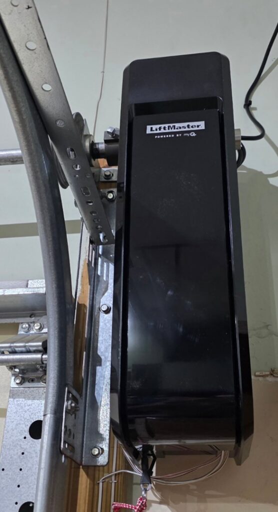 A technician repairing a garage door track with a power drill for Align Garage Door in Ringgold, GA.