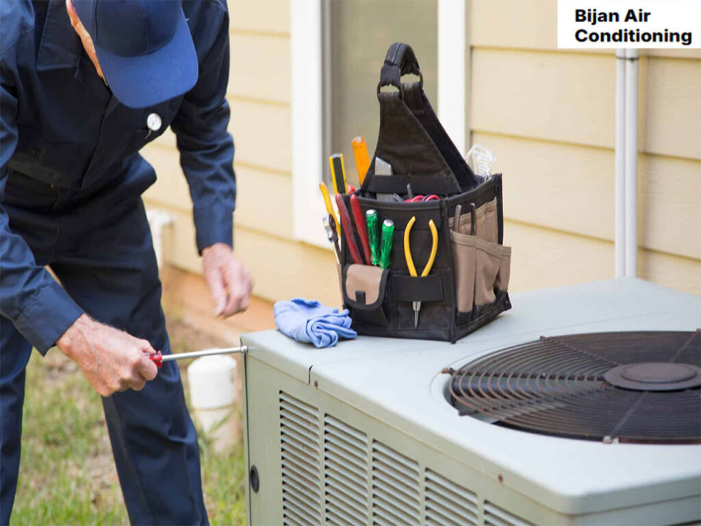 A technician repairing an outdoor HVAC condenser unit for Bijan Air-Conditioning in Chandler, AZ