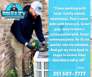 A Breezy Heating and Cooling technician repairing an outdoor HVAC unit in Mobile, AL.