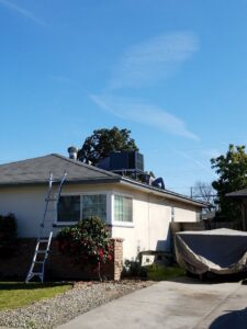 An HVAC technician on a roof performing service on a unit for All Pro Air in Warrenville, IL.