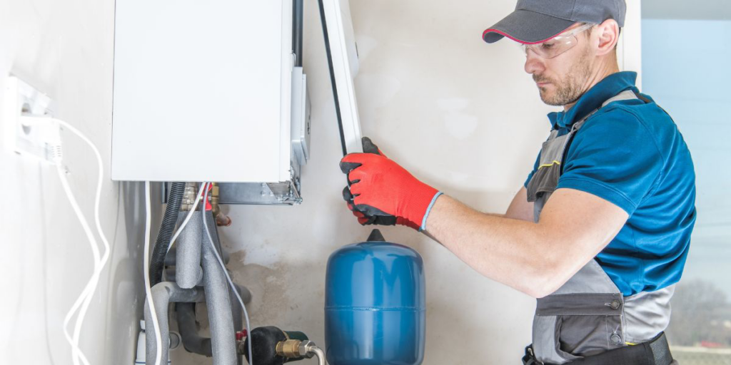 A technician servicing a boiler or heating system, a service provided by A-1 Electric Motor Service in Covington, KY.