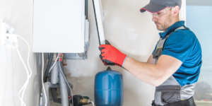 A technician servicing a boiler or heating system, a service provided by A-1 Electric Motor Service in Covington, KY.