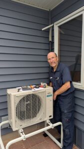 A technician servicing a Fujitsu mini-split outdoor unit for I & M Heating and Cooling in South Bend, IN.