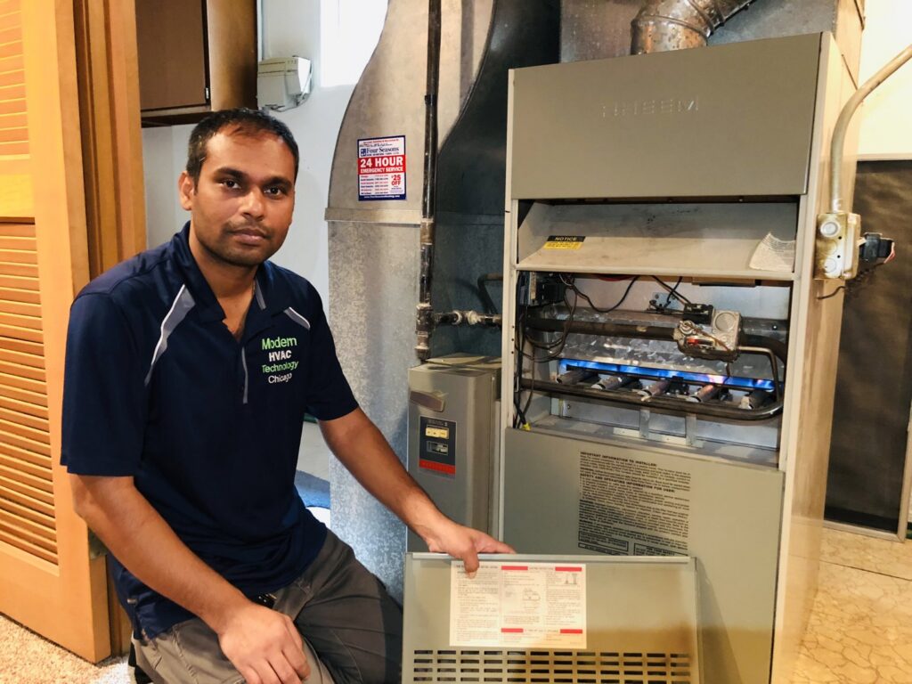 A technician servicing a furnace with lit burners, demonstrating expertise from Modern HVAC Technology in Chicago, IL.