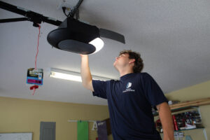 A Chase Door Systems technician servicing a garage door opener in Summerville, SC.