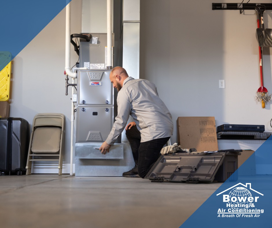 A skilled technician servicing an HVAC furnace unit for Bower Heating & Air Conditioning in Roanoke, VA