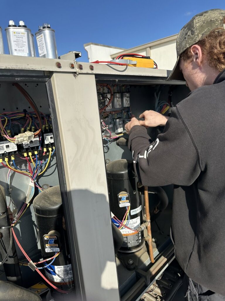 A technician servicing the internal components of a large HVAC unit for Green Mechanical LLC in Philadelphia, PA.
