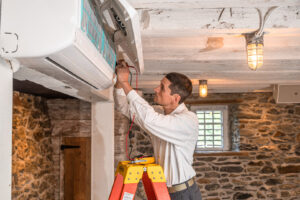 An HVAC technician servicing an indoor mini-split air conditioning unit for RSC Heating and Air Conditioning in Lancaster, PA.