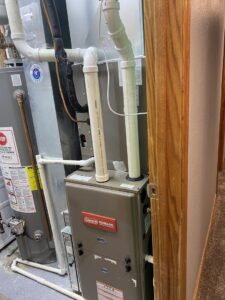 A technician servicing an outdoor air conditioning unit for a client of Climate Solutions. Inc. in Cape Coral, FL.