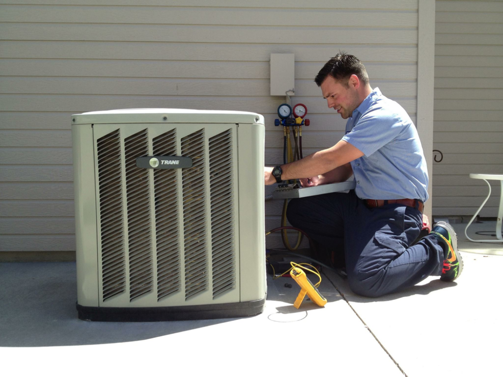 A skilled technician servicing an outdoor air conditioning unit for Glacier Air Conditioning & Refrigeration Ltd. in Chilliwack, BC.