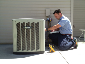 A skilled technician servicing an outdoor air conditioning unit for Glacier Air Conditioning & Refrigeration Ltd. in Chilliwack, BC.