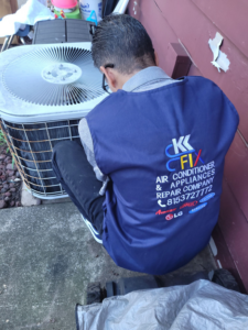 A technician performing maintenance on an outdoor AC condenser unit for HVAC and Appliances repair LLC in Arlington, VA.