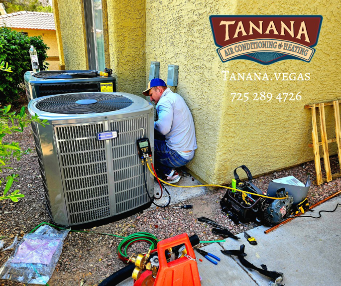A technician from Tanana Air Conditioning & Heating servicing an outdoor AC unit with tools on the ground in Las Vegas, NV.