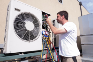 A technician servicing an outdoor HVAC unit with gauges at a property in Carmel, IN, by O'hare Heating and Air.