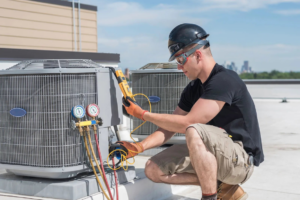 A technician servicing a rooftop AC unit with gauges for On the Spot Heating and Cooling in Overland Park, KS.