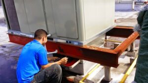 A technician servicing a large commercial rooftop HVAC unit for Enviromax Heating & Cooling in Peekskill, NY.