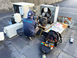 A Mr. Fridge technician servicing a commercial rooftop HVAC unit in Seattle, WA.