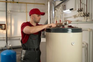 A technician servicing a water heater for Daniels HVAC Philadelphia LLC in Philadelphia, PA.