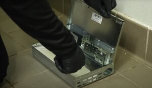 A pest control technician setting up a metal multi-catch mouse trap for Rodent Control Cleveland in Cleveland, OH.