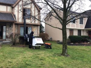 A technician setting up a bed bug heat treatment machine outside a residential home for Protective Thermal Solutions in Columbus, OH.