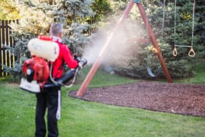 A Mosquito Shield of Savannah technician spraying a residential backyard for pest control in Savannah, GA.