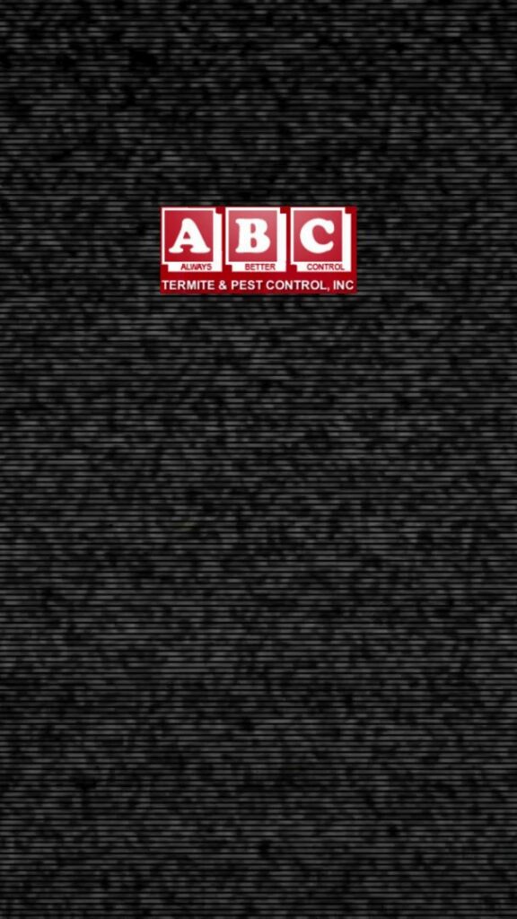 A pest control technician from ABC Termite & Pest Control, Inc spraying bushes with a backpack sprayer in Lincoln, NE.