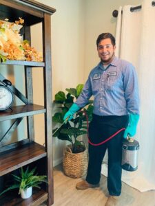 A Dan's Pest Management technician spraying for pests indoors in Bakersfield, CA