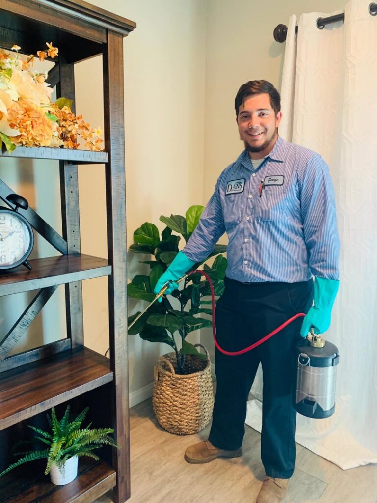 A Dan's Pest Management technician spraying for pests indoors in Bakersfield, CA