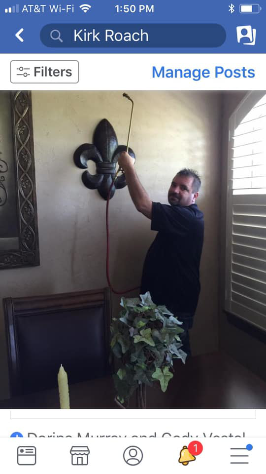 A technician from Roach's Termite Service Inc. spraying for pests indoors in Oklahoma City, OK