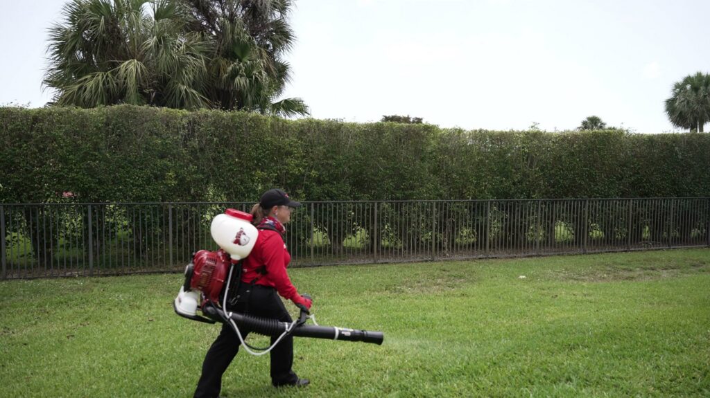 A Mosquito Shield of Savannah technician spraying a residential lawn for pest control in Savannah, GA.