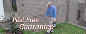 A technician spraying a building perimeter for pest control by Curry's Termite, Pest & Animal Control in Little Rock, AR