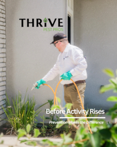 A Thrive Pest Pros technician spraying pest control solution around the foundation of a home in Clovis, CA.