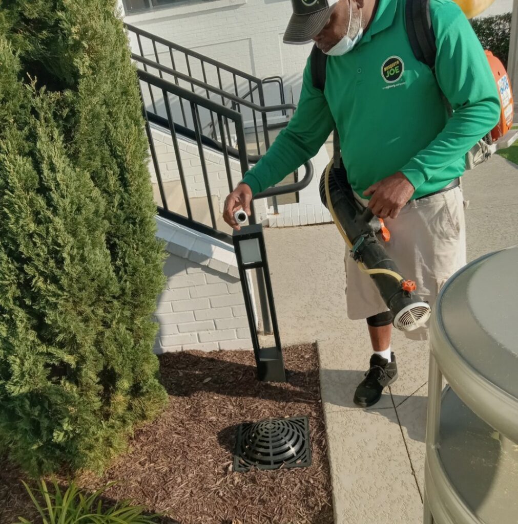 A Mosquito Joe of Columbia technician applying a pest control treatment with a backpack sprayer in Columbia, SC.