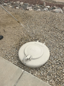 A technician from Preferred Choice Pest Control applying pest treatment to the ground in Surprise, AZ.