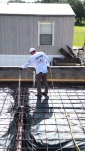 A Blessed Pest Control technician applying a pre-construction termite treatment to a foundation in San Antonio, TX