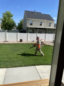 A Mosquito Hunters of Layton-Kaysville-Farmington technician spraying a residential yard for pest control in Layton, UT.