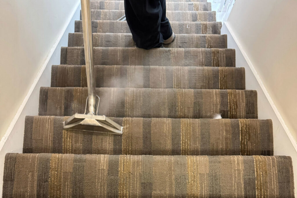 A technician from Get Steamed Carpet Cleaning, Inc. steam cleaning carpeted stairs in North Charleston, SC.