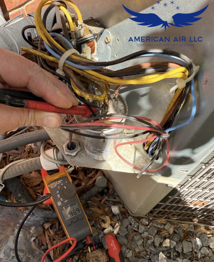 A technician from American Air LLC testing electrical components inside an outdoor AC unit with a multimeter in Moncks Corner, SC
