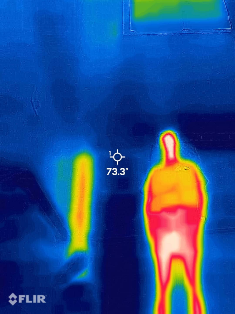 A technician performing a thermal inspection to locate a pest infestation for A&E Bee Extraction and Control in Mount Pleasant, SC.