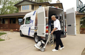 An ABC Chem-Dry St. Louis technician unloading carpet cleaning equipment from a company van in St Charles, MO.